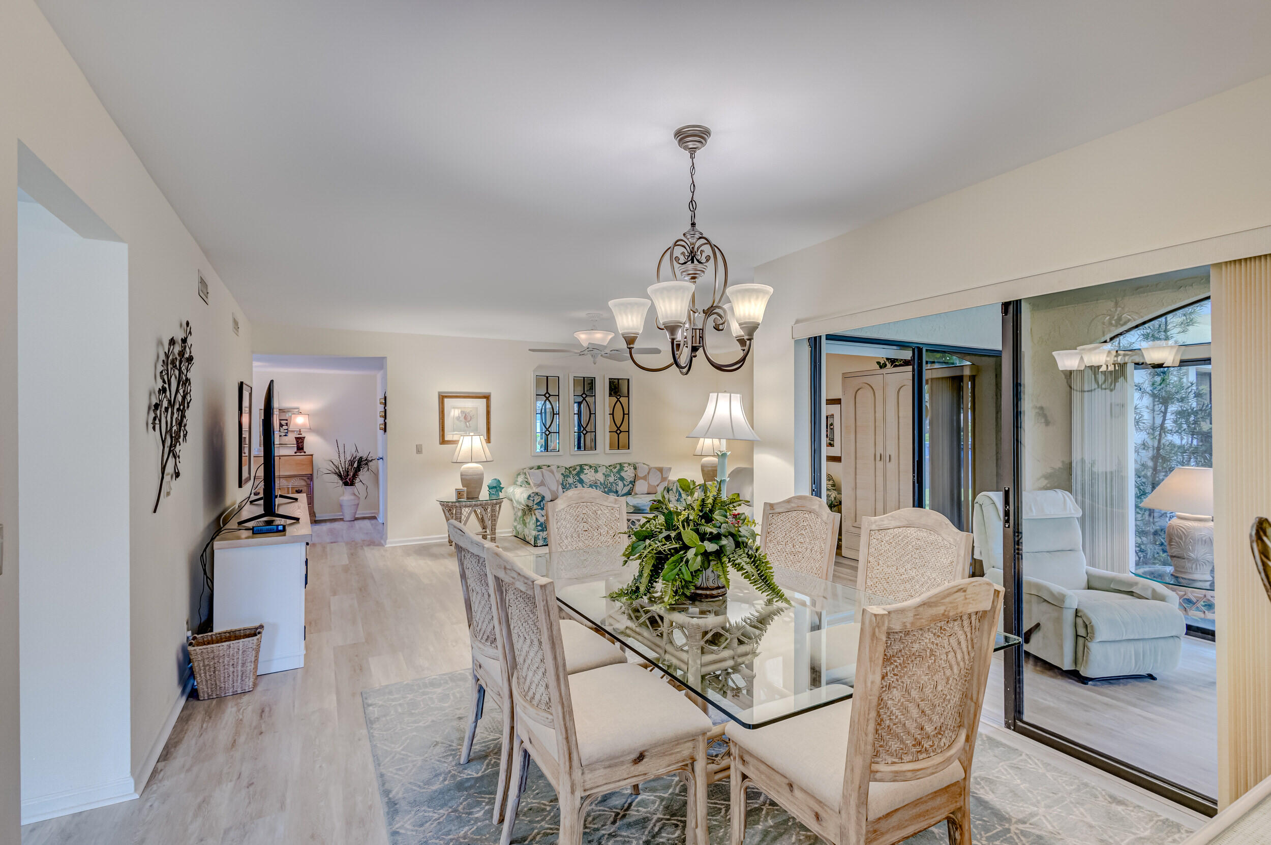 16623 Traders Crossing North, Unit 131 Jupiter, FL 33477 - Photo 10 of 42 a view of a dining room with furniture and chandelier