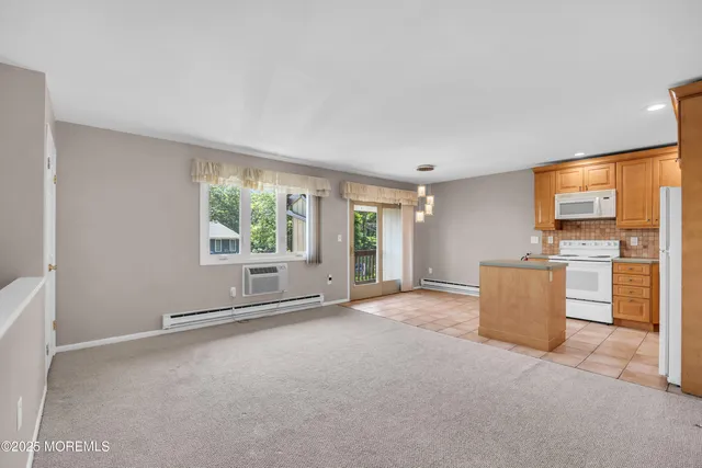 an empty room with furniture and window