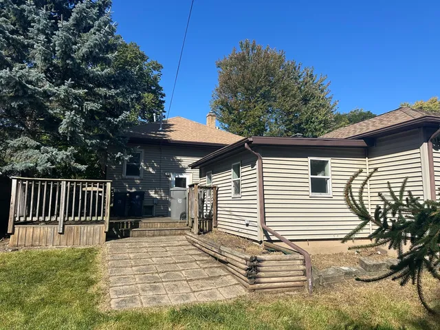 a backyard of a house with table and chairs