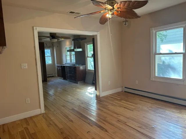 wooden floor in an empty room with a window