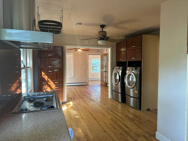 a view of a hallway with entryway wooden floor and front door