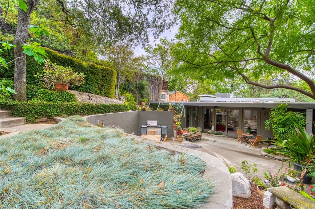 a view of a patio with table and chairs under an umbrella