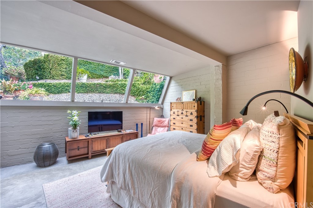 600 Chaparral Road Sierra Madre, CA 91024 - Photo 16 of 25 a bedroom with a bed and a fireplace