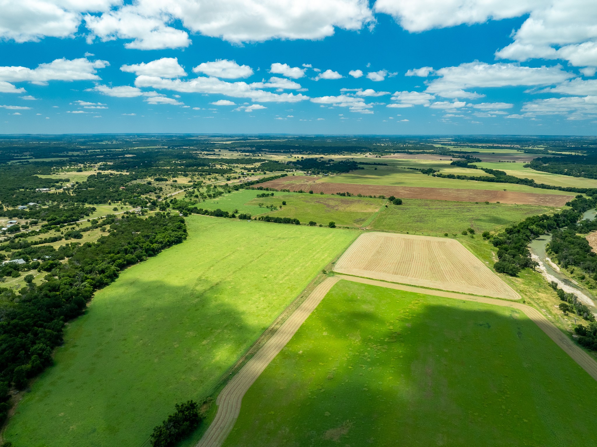 8044 580th Street East Kempner, TX 76539 - Photo 3 of 40 Vast green fields and wooded areas define this serene agricultural landscape.