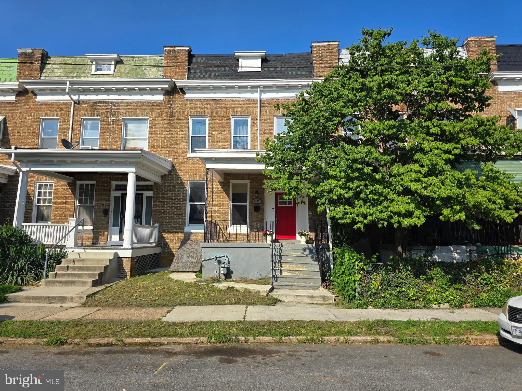 3105 Chelsea Terrace Baltimore, MD 21216 - Photo 1 of 58 front view of a house with a tree