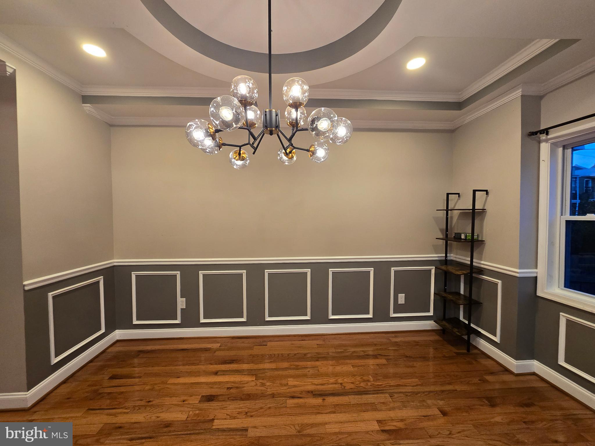 3105 Chelsea Terrace Baltimore, MD 21216 - Photo 13 of 58 a view of an empty room with wooden floor and a kitchen