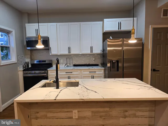 a kitchen with a sink and a refrigerator