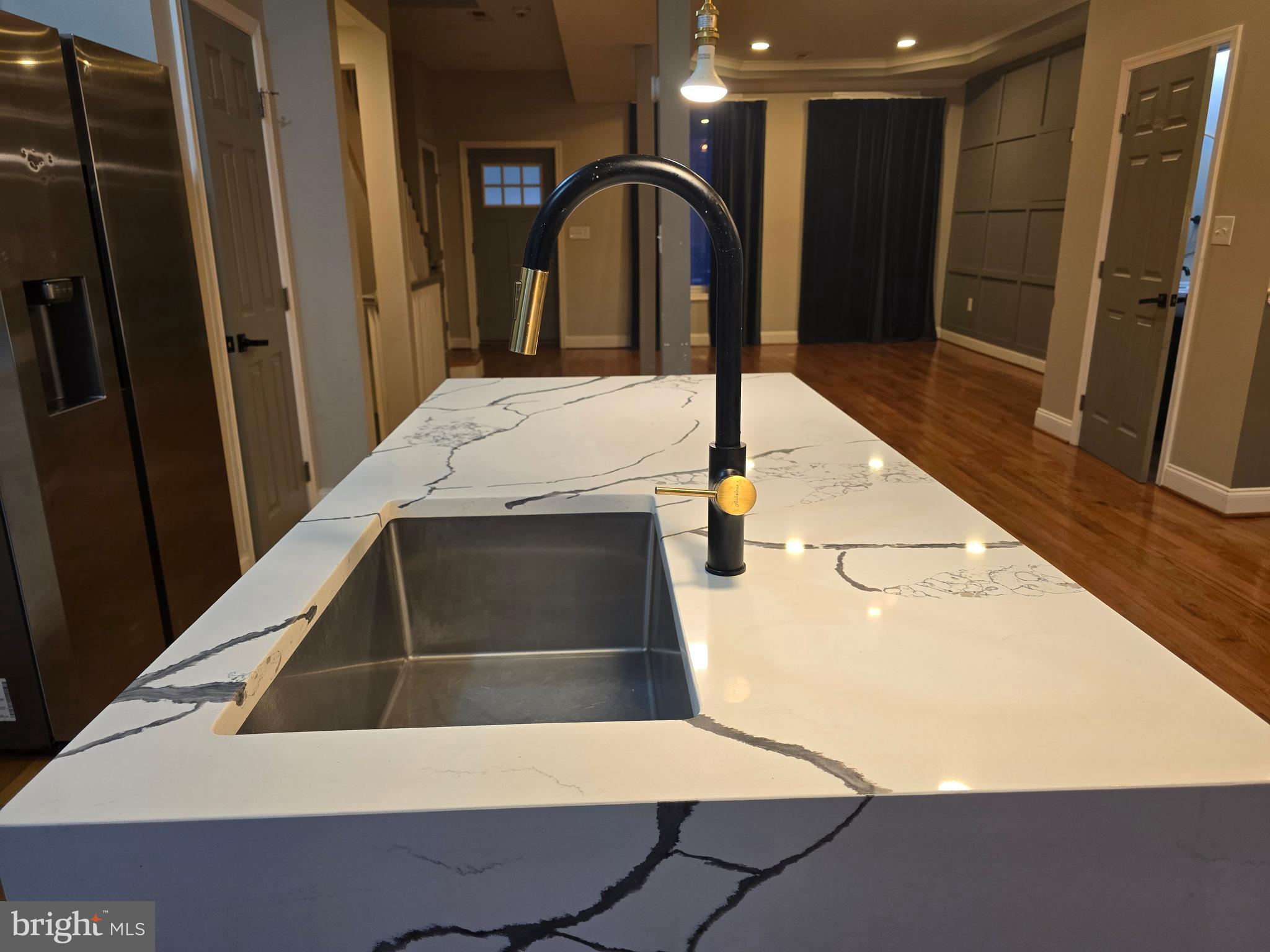 3105 Chelsea Terrace Baltimore, MD 21216 - Photo 15 of 58 a kitchen with a sink and a refrigerator