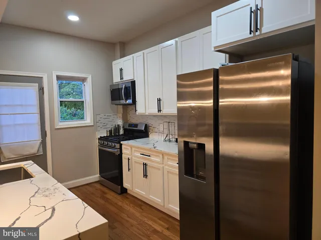 a kitchen with granite countertop a stove and a sink