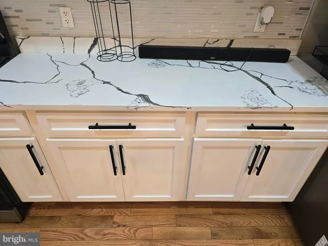 a kitchen with granite countertop a stove a sink and a microwave