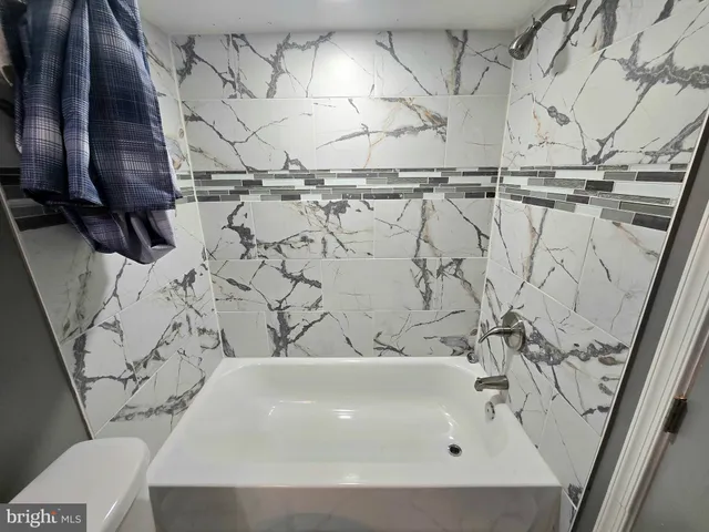a bathroom with a glass shower door