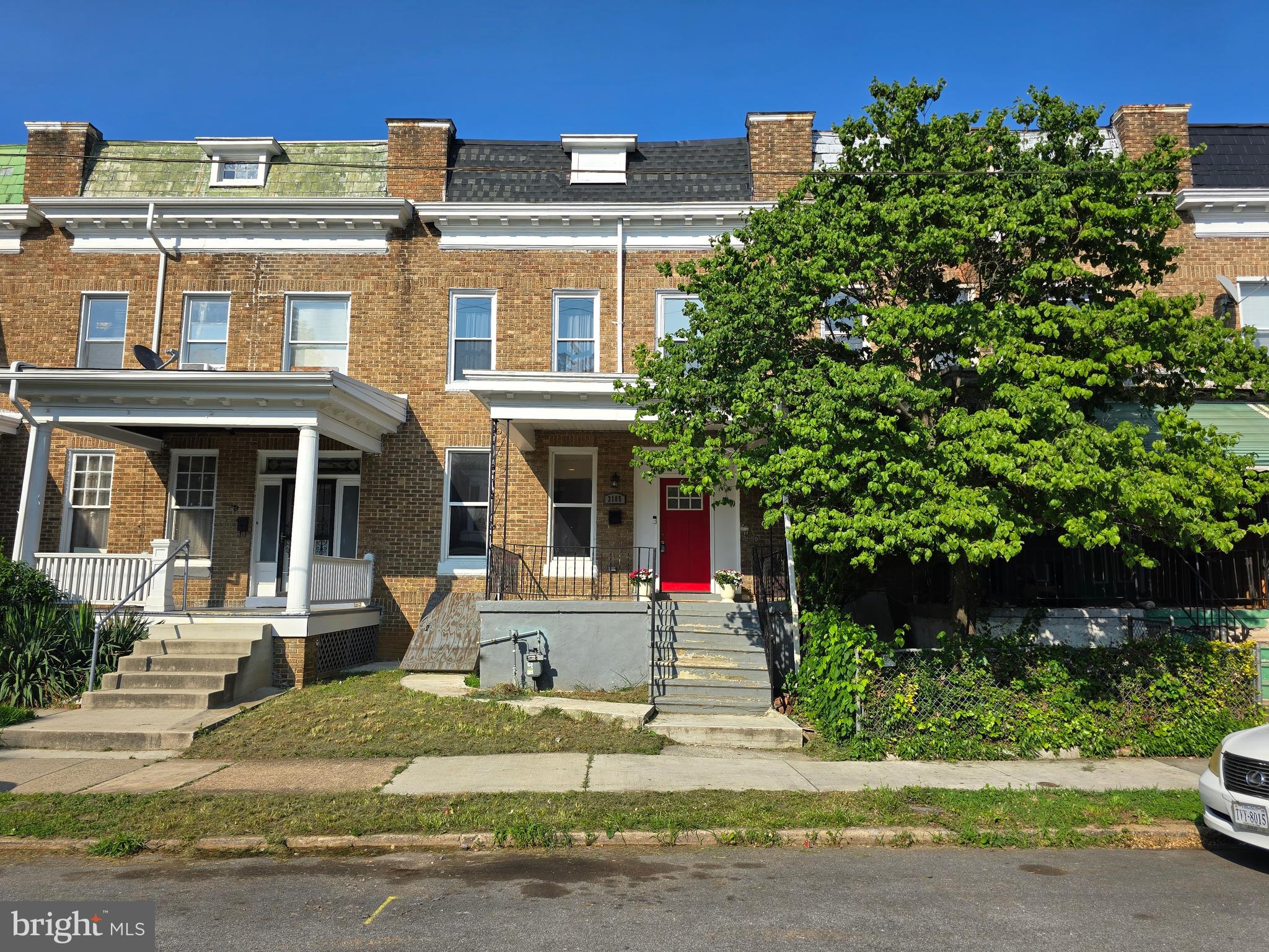 3105 Chelsea Terrace Baltimore, MD 21216 - Photo 4 of 58 front view of a house with a tree