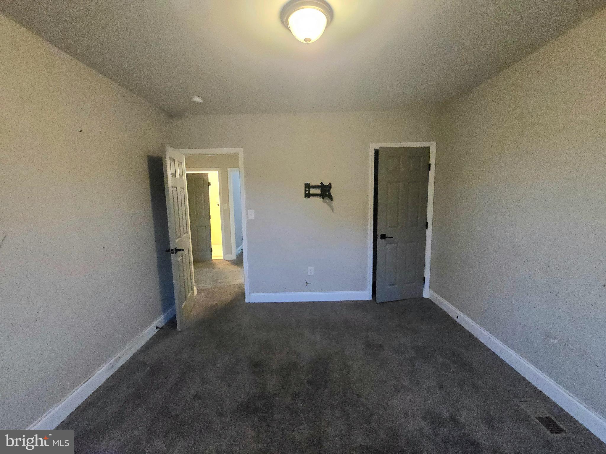 3105 Chelsea Terrace Baltimore, MD 21216 - Photo 44 of 58 an empty room with closet and mirror