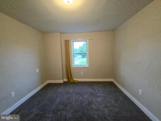 a view of a backyard with a swing and wooden fence