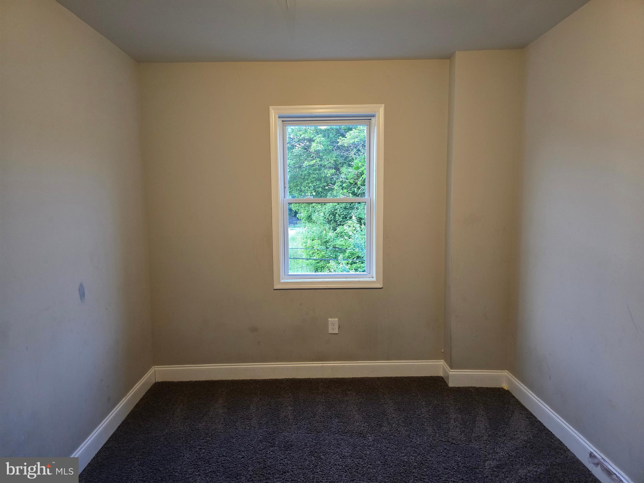 3105 Chelsea Terrace Baltimore, MD 21216 - Photo 50 of 58 a view of an empty room with wooden floor and a window