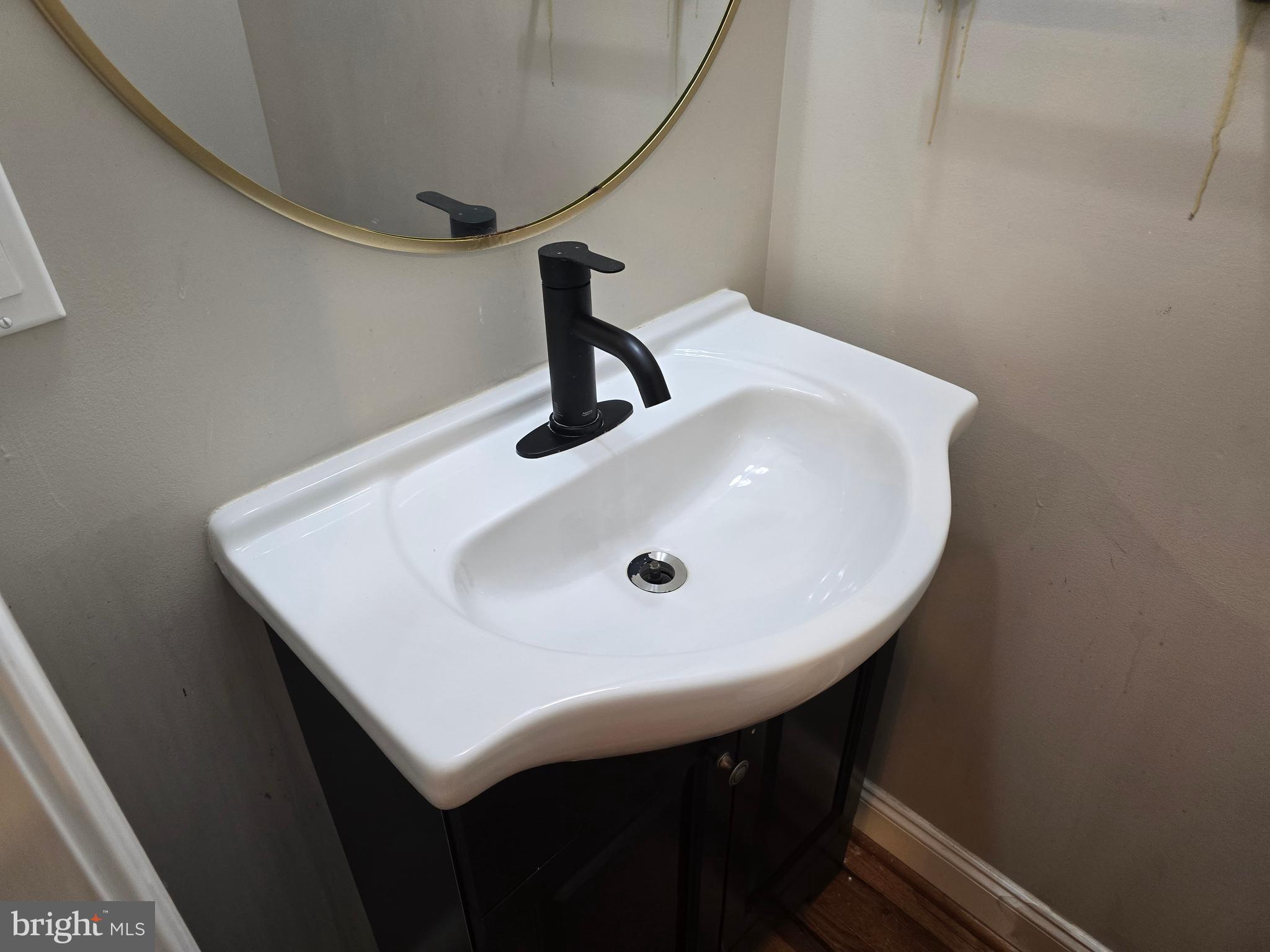 3105 Chelsea Terrace Baltimore, MD 21216 - Photo 55 of 58 a bathroom with a sink and mirror