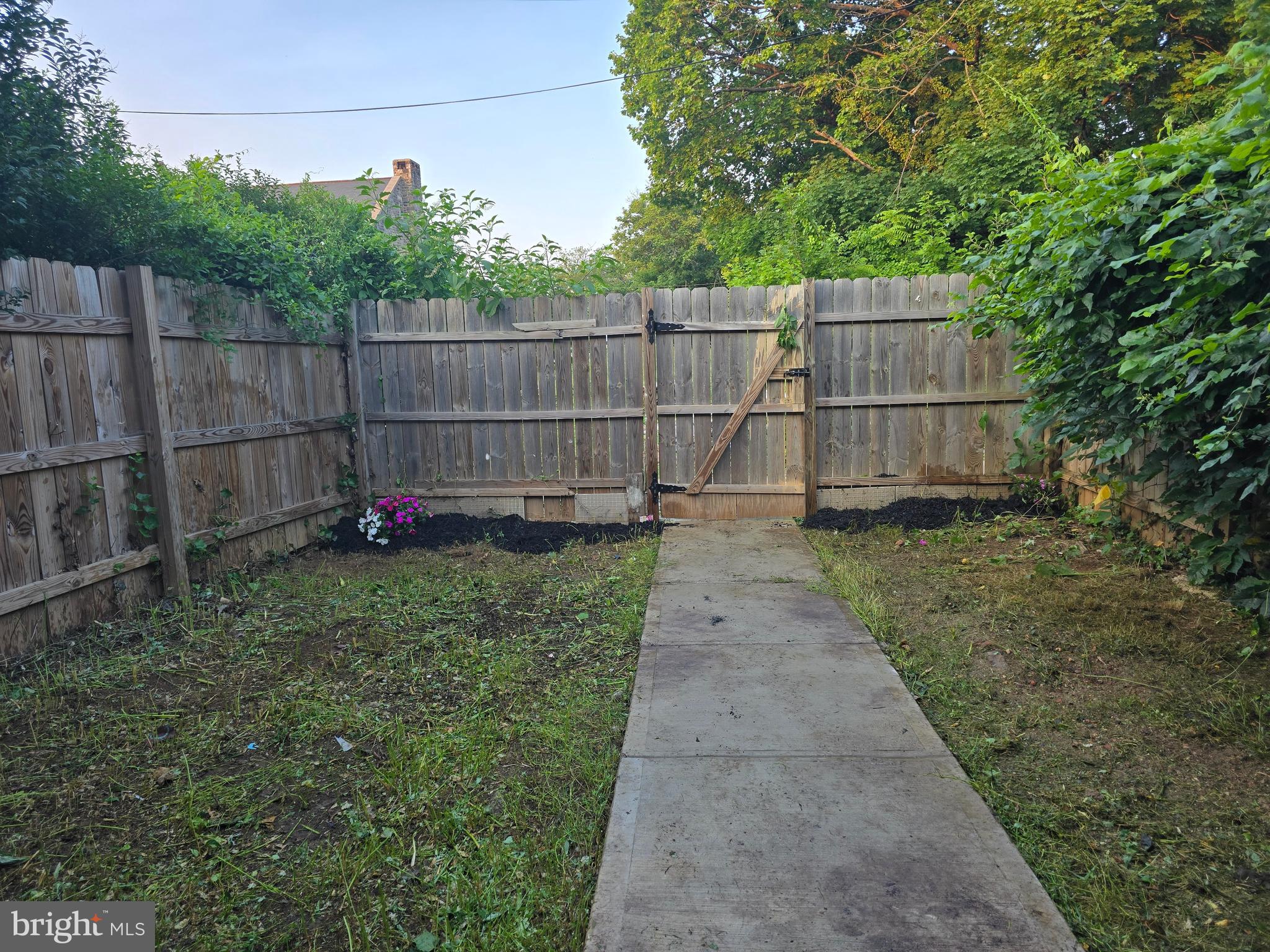 3105 Chelsea Terrace Baltimore, MD 21216 - Photo 56 of 58 a view of a backyard with a swing and wooden fence