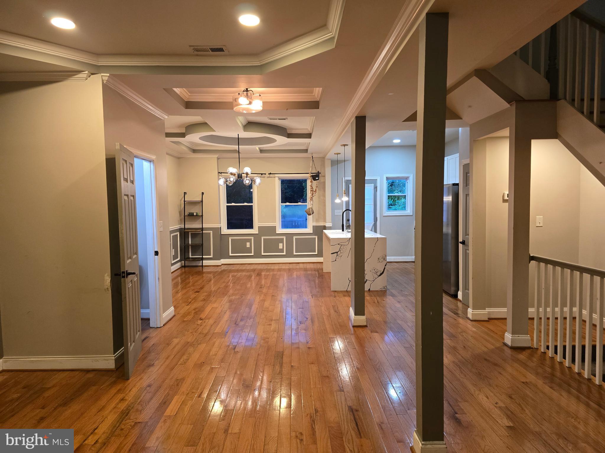 3105 Chelsea Terrace Baltimore, MD 21216 - Photo 8 of 58 a view of a hallway with wooden floor and chandelier