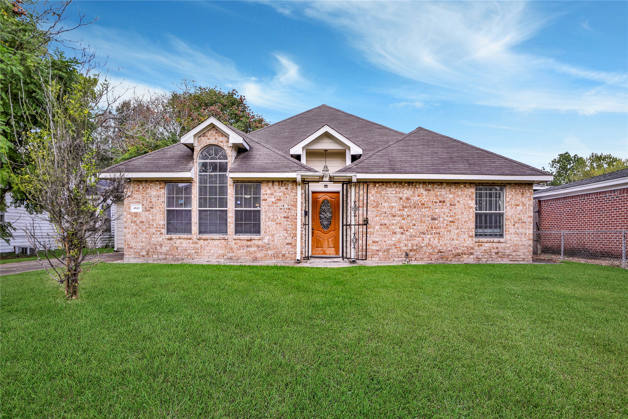a front view of a house with a garden