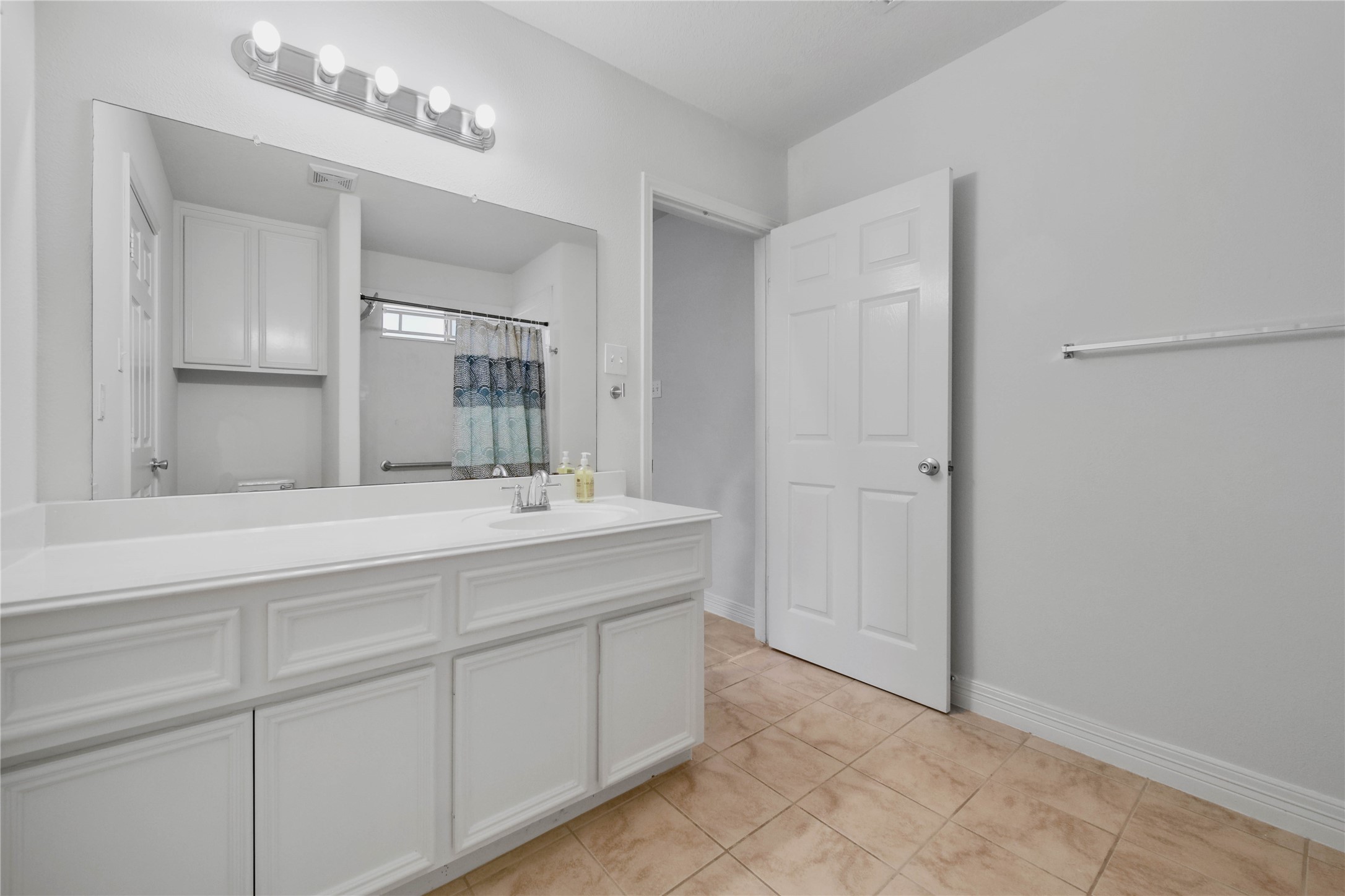 4943 Gammage Street Houston, TX 77021 - Photo 18 of 22 a bathroom with a double vanity sink and a mirror