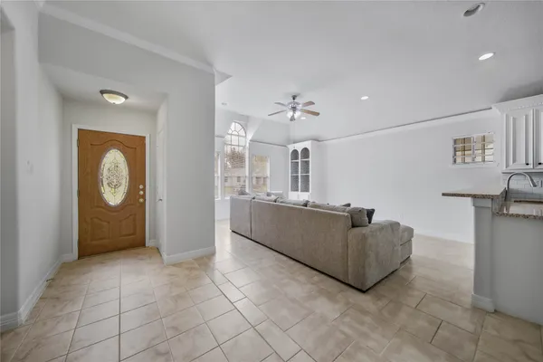a living room with furniture and a open kitchen view