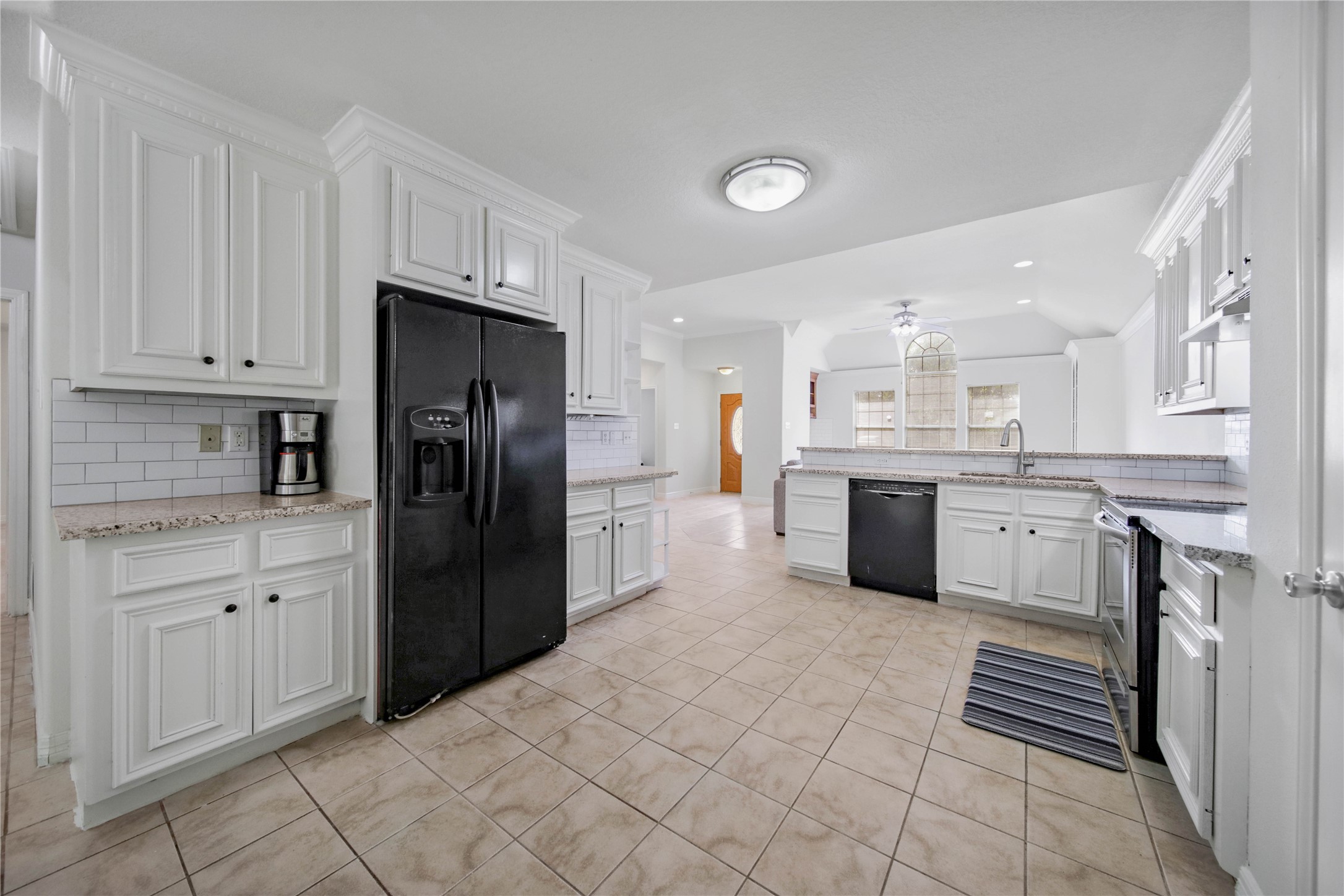4943 Gammage Street Houston, TX 77021 - Photo 7 of 22 a kitchen with stainless steel appliances a refrigerator sink and cabinets