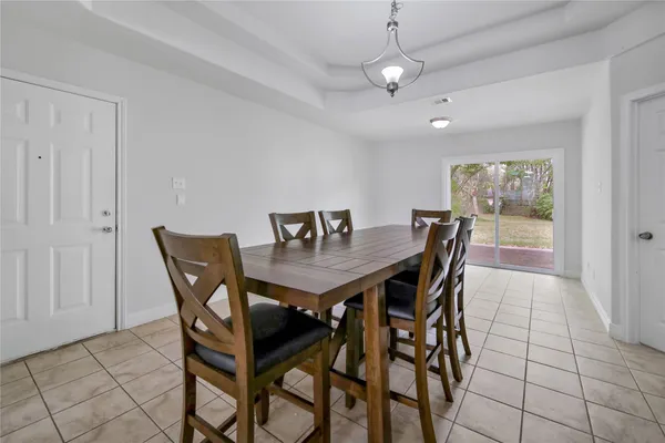 a view of a dining room with furniture and a chandelier