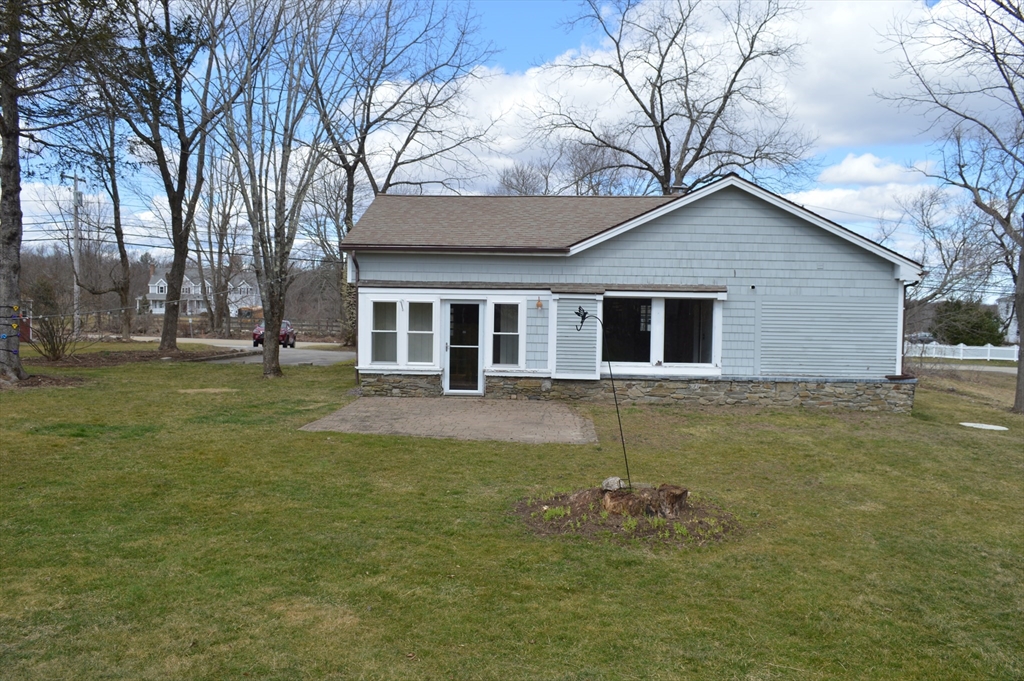 101 Putnam Hill Road Sutton, MA 01590 - Photo 25 of 26 a backyard of a house with table and chairs