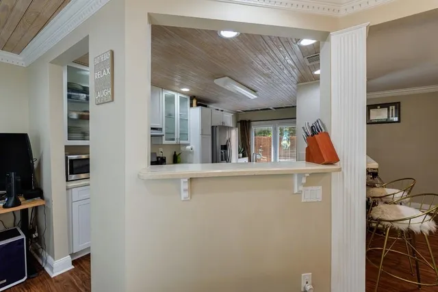 a kitchen with stainless steel appliances granite countertop a refrigerator a stove and a sink