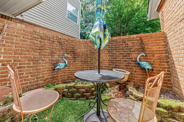 a kitchen with a stove a sink and white cabinets with wooden floor