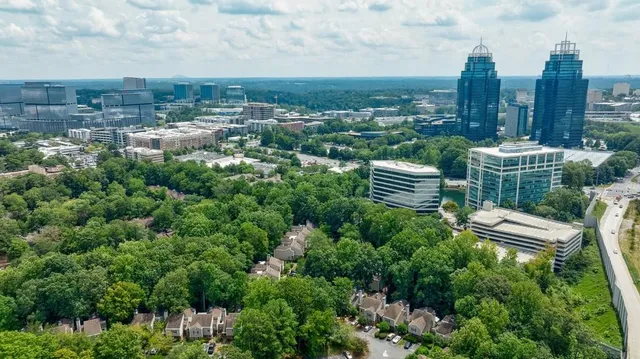 an aerial view of residential house with outdoor space and trees around