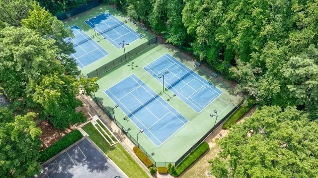 an aerial view of a house with a yard and lake view