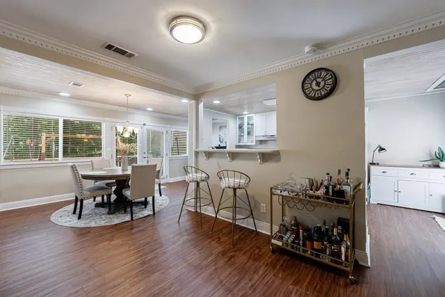 a dining room with furniture and wooden floor