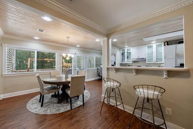 a dining room with furniture and wooden floor