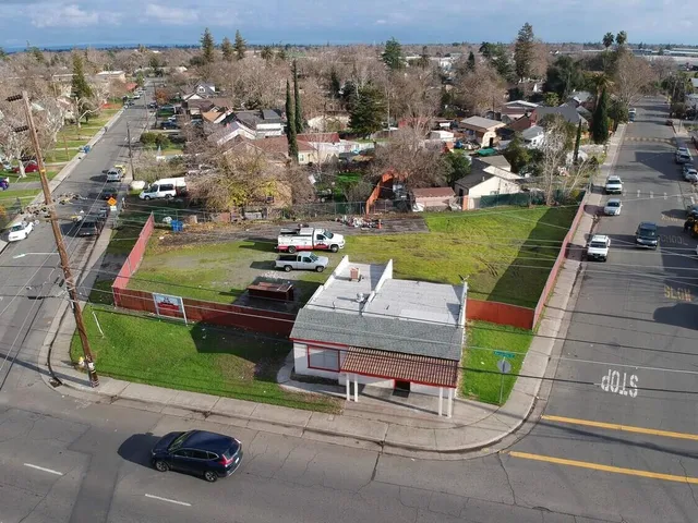 an aerial view of a house with a garden and parking space