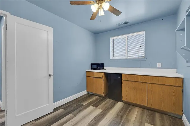 a kitchen with a refrigerator and cabinets