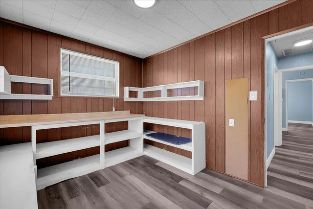 a view of an empty room with a fireplace and a window