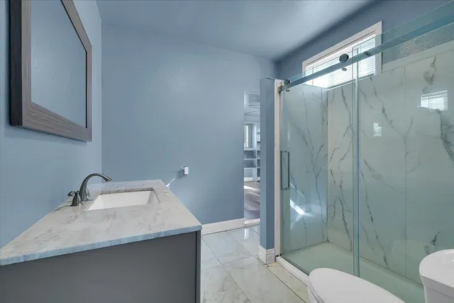 a bathroom with a sink toilet and shower