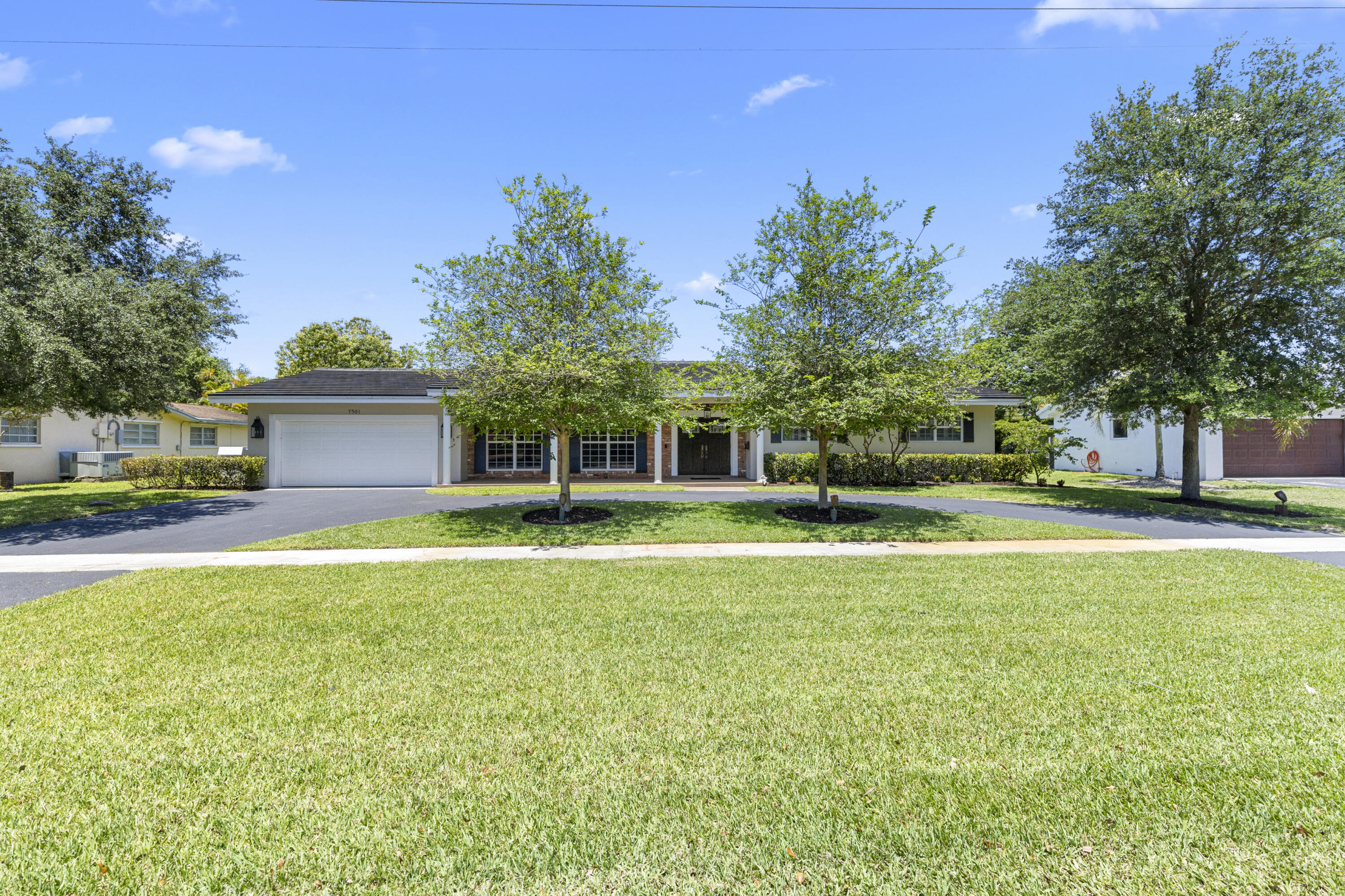 7501 Plantation Road Plantation, FL 33317 - Photo 1 of 57 a front view of a house with a garden