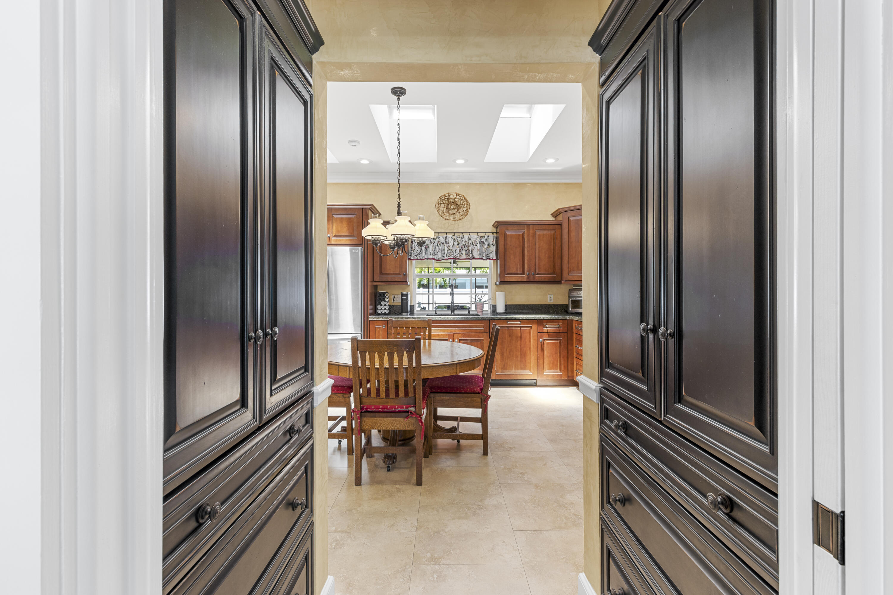 7501 Plantation Road Plantation, FL 33317 - Photo 13 of 57 a kitchen with stainless steel appliances granite countertop dining table chairs and a refrigerator