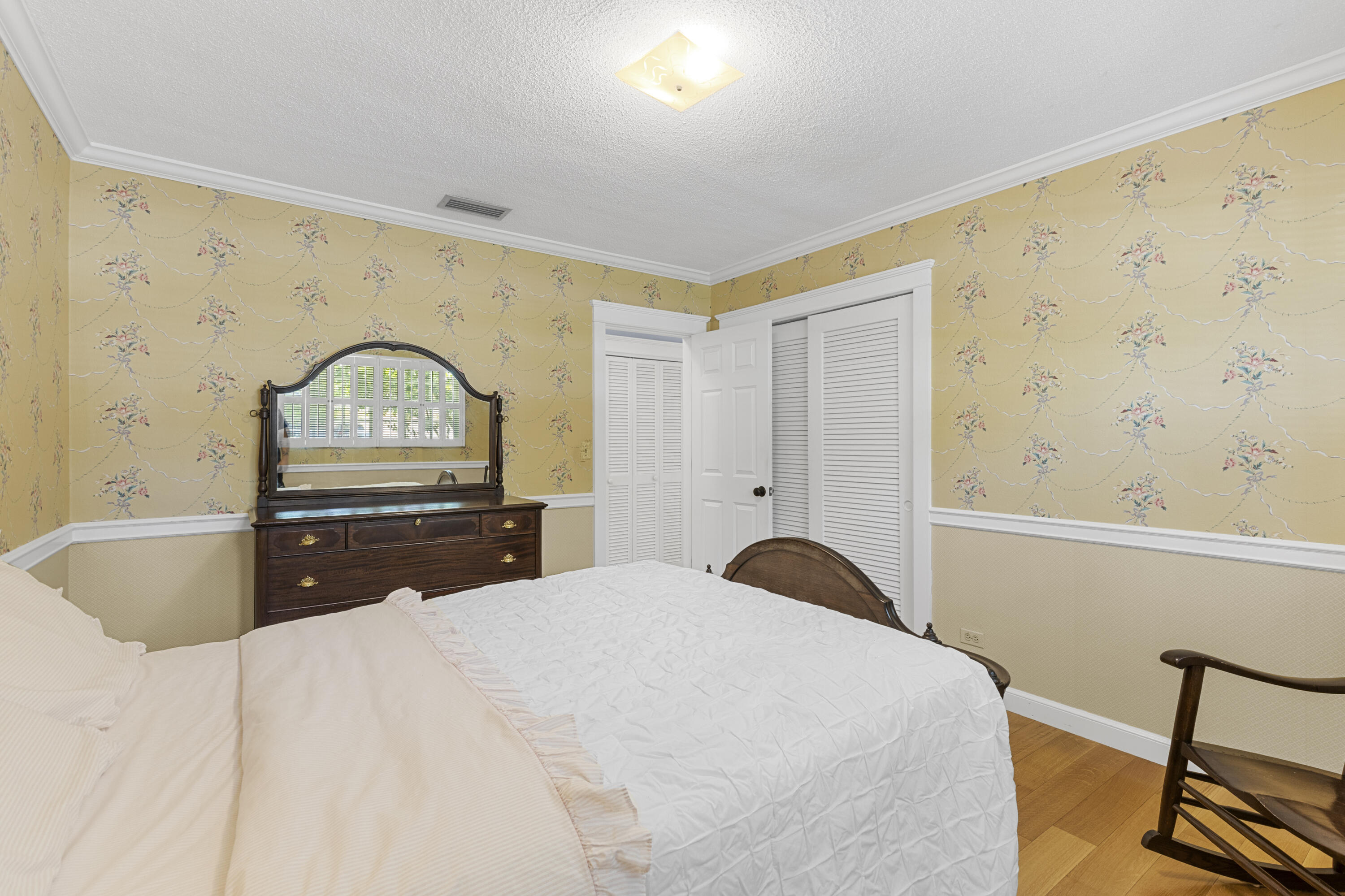 7501 Plantation Road Plantation, FL 33317 - Photo 25 of 57 a bedroom with a bed and a dresser with wooden floor
