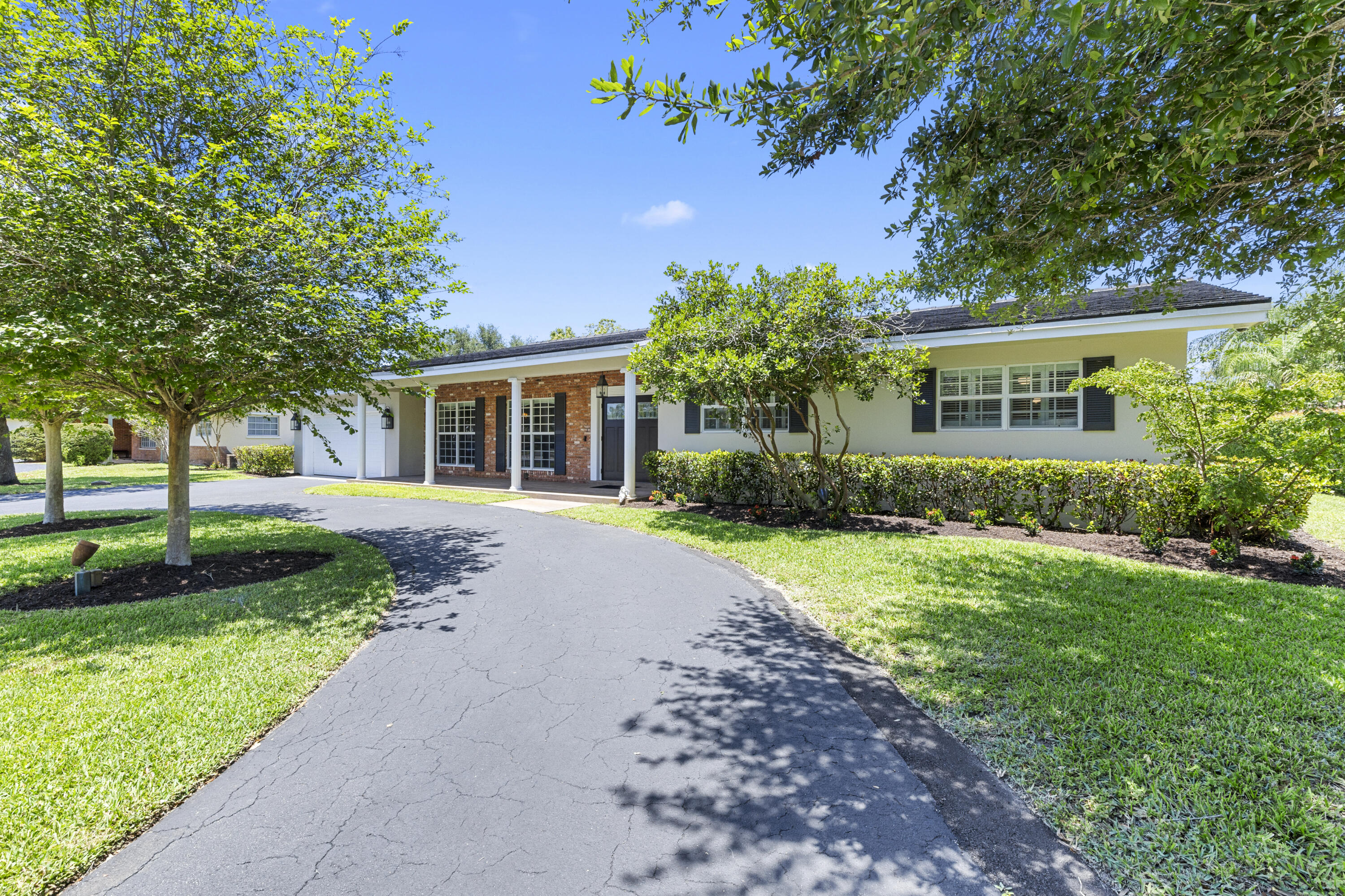 7501 Plantation Road Plantation, FL 33317 - Photo 3 of 57 a front view of a house with garden
