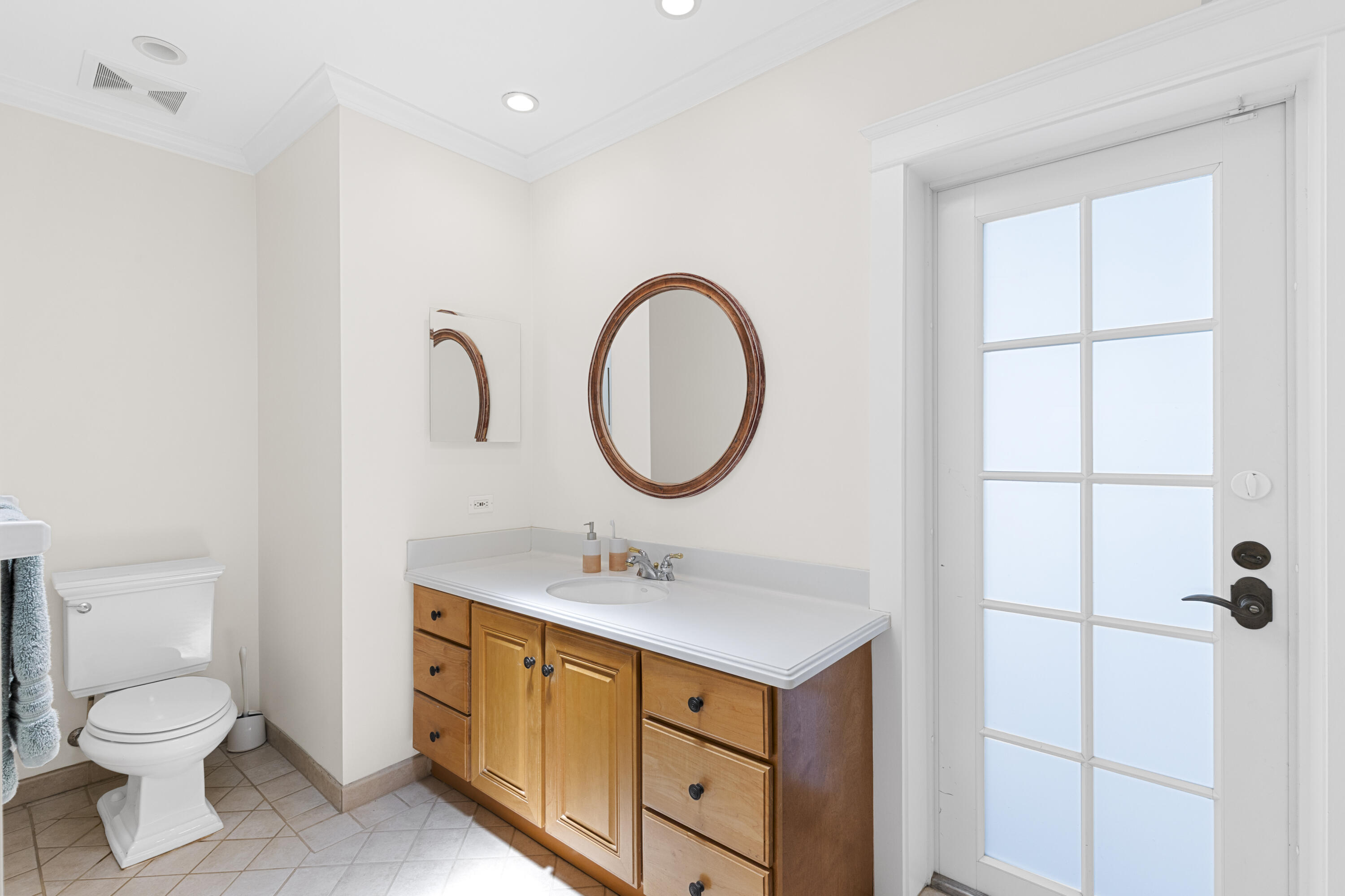 7501 Plantation Road Plantation, FL 33317 - Photo 37 of 57 a bathroom with a toilet sink and mirror