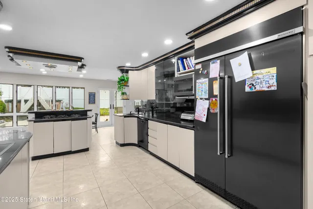 a kitchen with stainless steel appliances granite countertop a refrigerator and a stove top oven