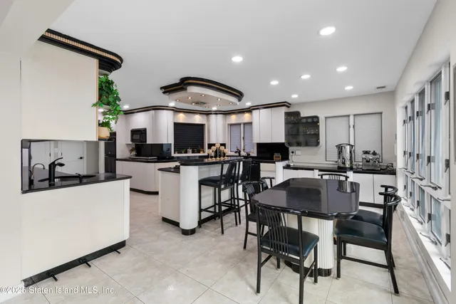 a kitchen with a sink a counter top stainless steel appliances and cabinets