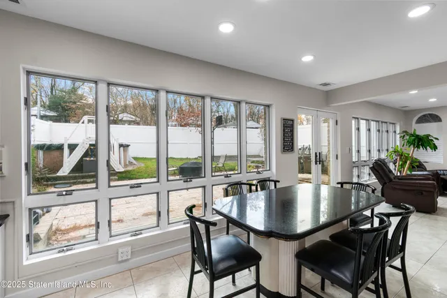 a dining room with furniture a chandelier and wooden floor