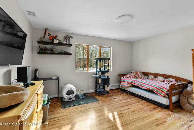 a bedroom with furniture and a flat screen tv