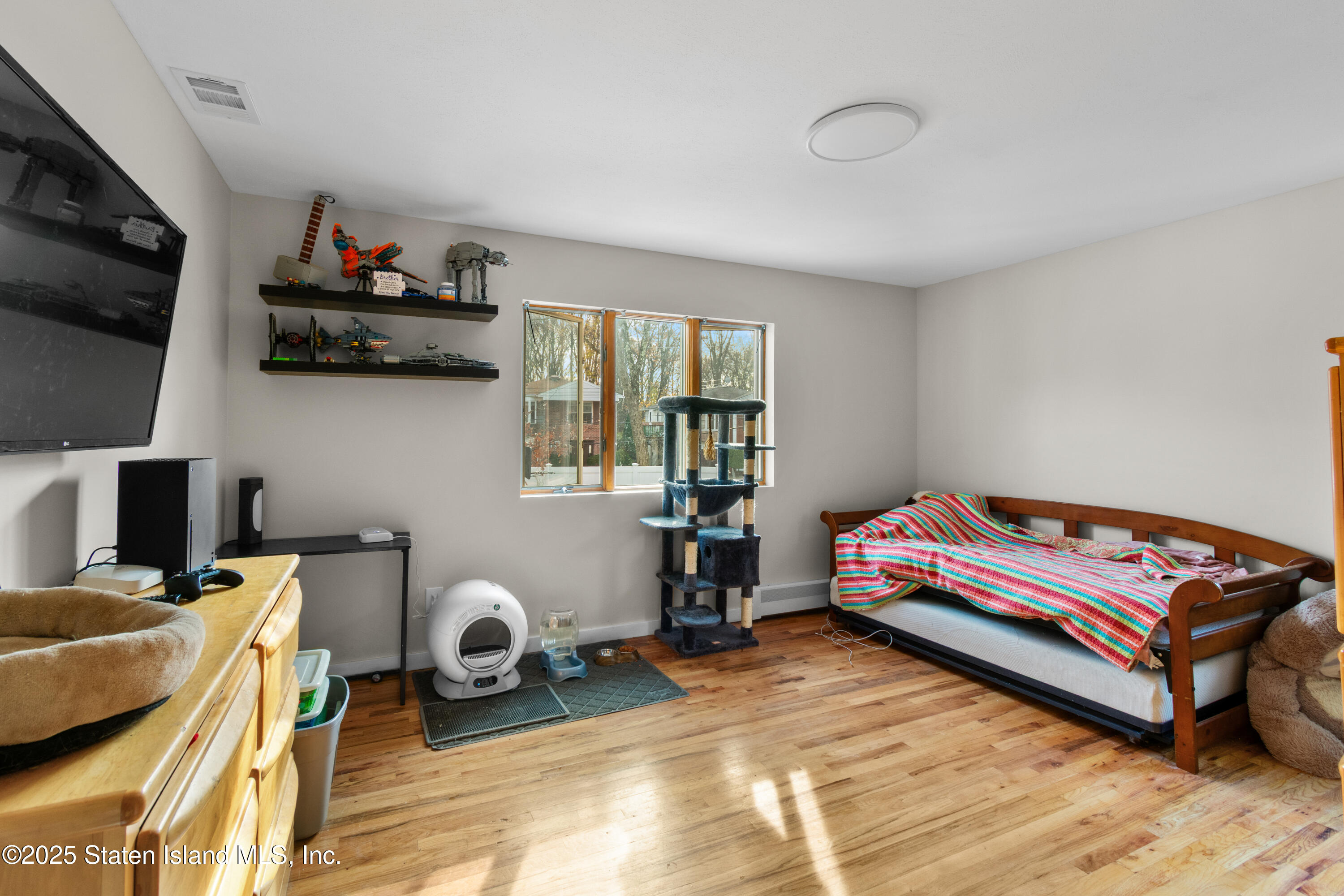 16 Ismay Street Staten Island, NY 10314 - Photo 21 of 39 a bedroom with furniture and a flat screen tv