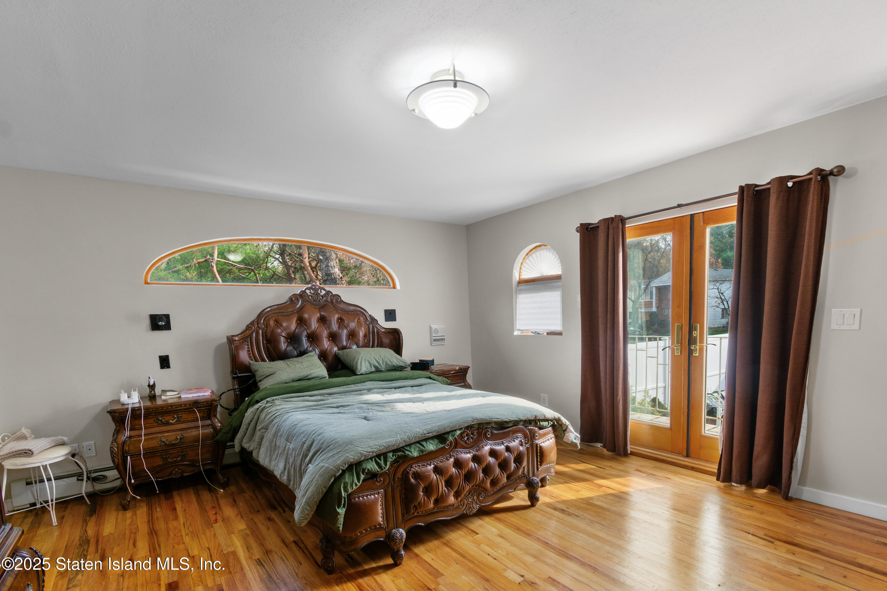 16 Ismay Street Staten Island, NY 10314 - Photo 22 of 39 a bedroom with a bed and a chandelier