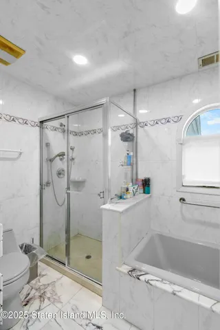 a bathroom with a shower and a toilet